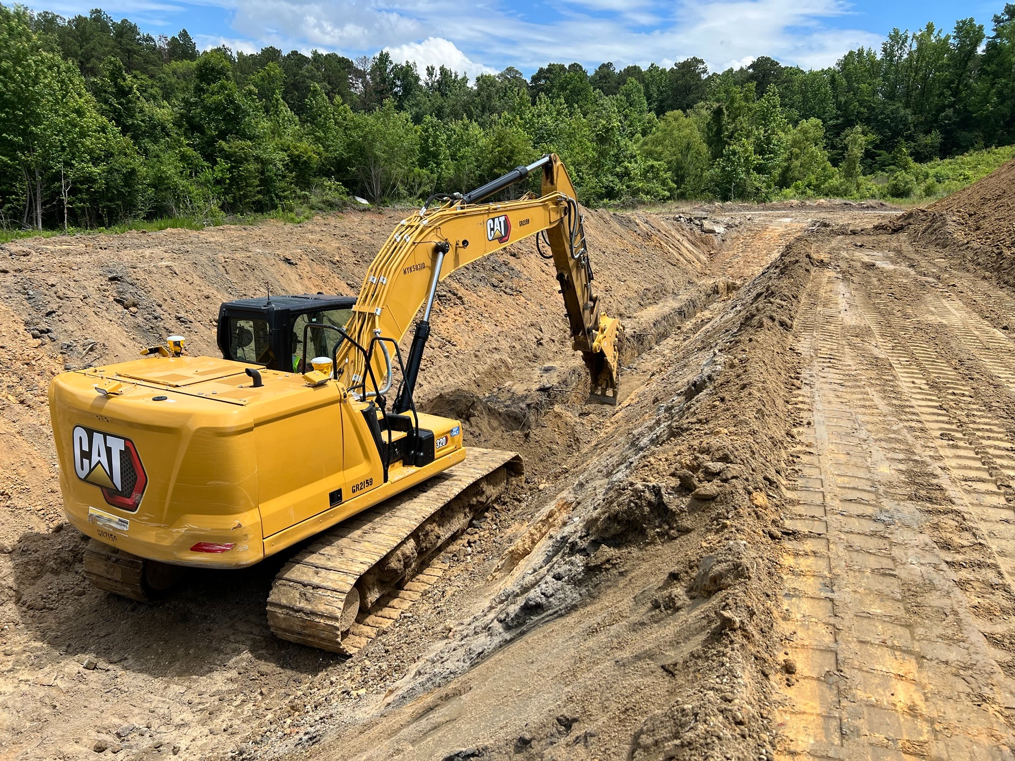 Large excavator performing mass excavation for underground mission-critical infrastructure